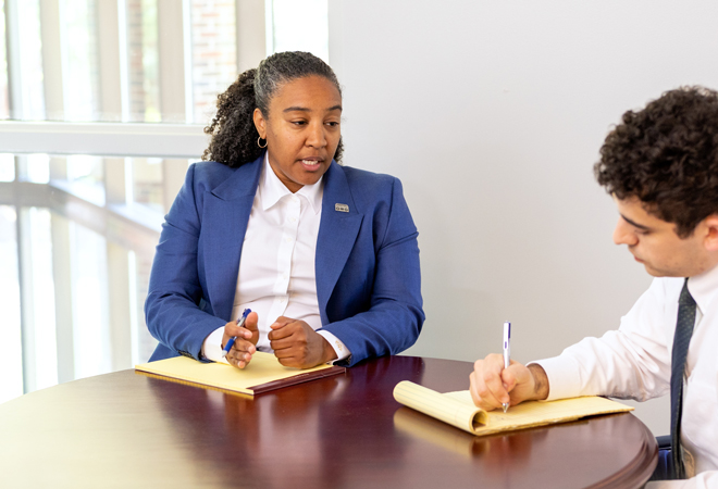 2 lawyers writing in a note pad