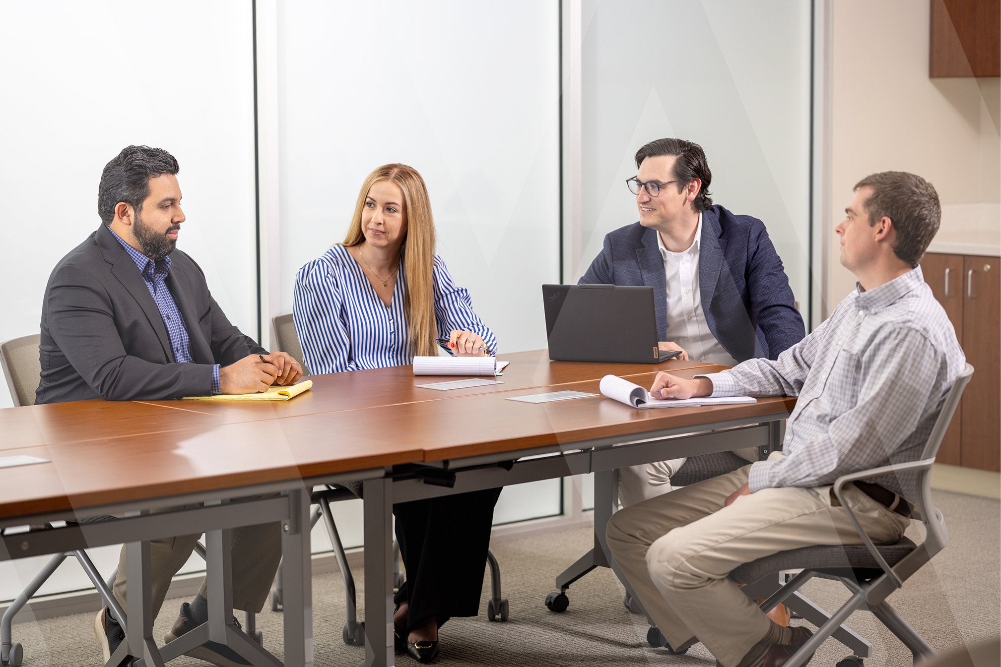 4 lawyers sitting at a table together